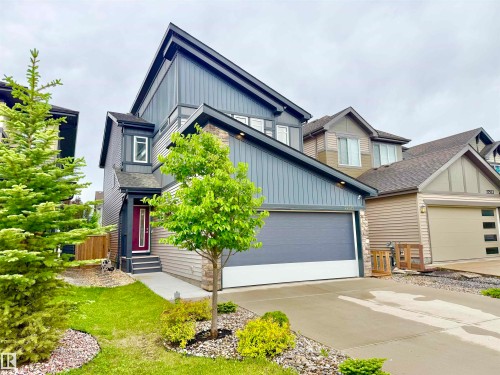 Modern two-story residence featuring a striking angular roofline and a deep red front door - 22519 96 Avenue, Edmonton, AB 