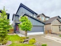 Modern two-story residence featuring a striking angular roofline and a deep red front door - 22519 96 Avenue, Edmonton, AB 