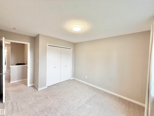 Neutral-toned bedroom with light gray walls and plush carpeting - 22519 96 Avenue, Edmonton, AB 