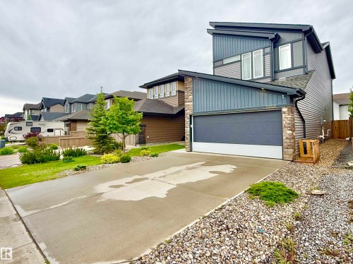 Contemporary two-story residence featuring multi-tone siding and stone accents - 22519 96 Avenue, Edmonton, AB 