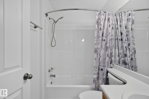 White bathtub and shower combination with a curved shower rod - 6225 159A Avenue, Edmonton, AB 