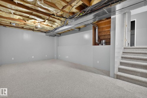 Expansive unfinished basement featuring light gray painted walls and light gray carpeted flooring - 6225 159A Avenue, Edmonton, AB 