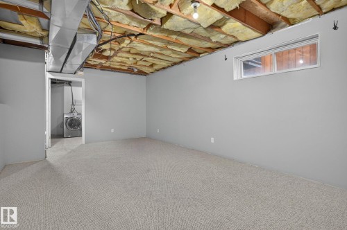 Spacious room with light gray walls and carpeted flooring - 6225 159A Avenue, Edmonton, AB 