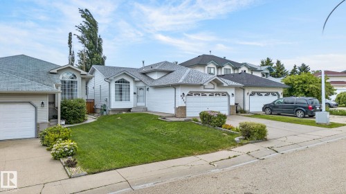 Single-story home featuring a two-car garage, white siding exterior, and a gabled roof - 6225 159A Avenue, Edmonton, AB 
