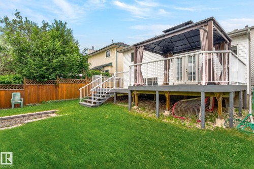 Expansive backyard featuring a multi-level deck, gazebo, private wood fencing, and a stone retaining wall - 6225 159A Avenue, Edmonton, AB 