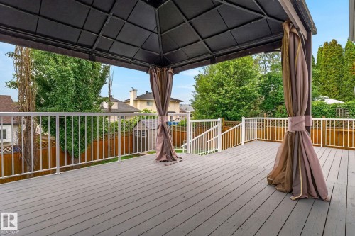 Spacious outdoor deck featuring gray composite decking and white railings - 6225 159A Avenue, Edmonton, AB 
