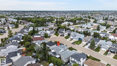 Aerial perspective of a residential neighborhood featuring numerous detached homes with varied rooflines and landscaping - 6225 159A Avenue, Edmonton, AB 