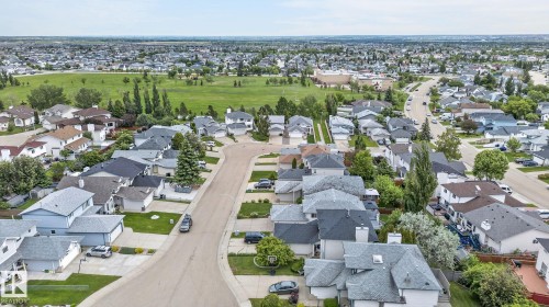 Residential neighborhood featuring varied single-family homes, mature landscaping, and a central green space - 6225 159A Avenue, Edmonton, AB 