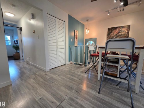Wood-finish flooring throughout, complemented by crisp white baseboards - 2514 149 Avenue, Edmonton, AB 