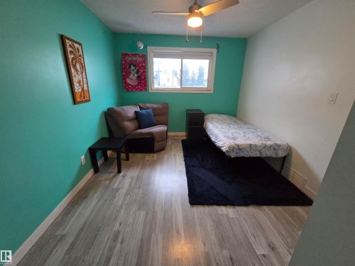 Room featuring wood-finish flooring and a ceiling fan with integrated lighting - 2514 149 Avenue, Edmonton, AB 