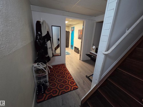 Hardwood staircase with white railing and paneled wall - 2514 149 Avenue, Edmonton, AB 