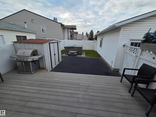 Expansive composite deck overlooking a paved patio area - 2514 149 Avenue, Edmonton, AB 