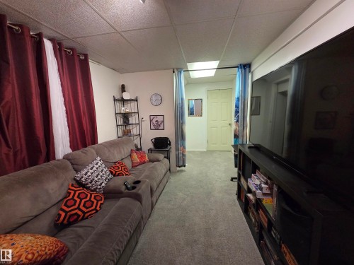 Carpeted room featuring a drop ceiling with recessed lighting - 2514 149 Avenue, Edmonton, AB 
