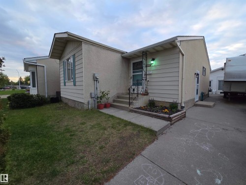 Stucco and siding exterior with a concrete driveway and walkway - 2514 149 Avenue, Edmonton, AB 