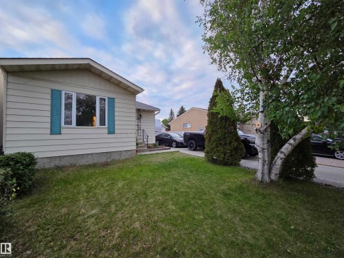 Property exterior featuring horizontal siding, a gabled roofline, and decorative window shutters - 2514 149 Avenue, Edmonton, AB 