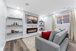 Integrated media wall featuring a linear electric fireplace and recessed television space - 