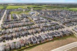 Aerial perspective of a developed residential area featuring rows of single-family homes and multi-family residences - 