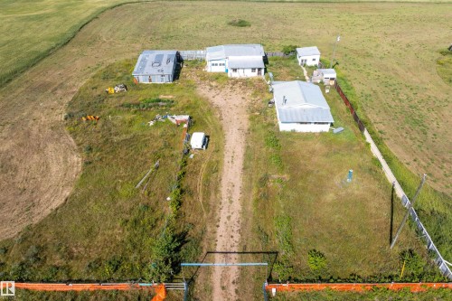 Aerial view showcasing the property's multiple outbuildings and expansive land - 534072 Range Road 85, Rural Two Hills County, AB 