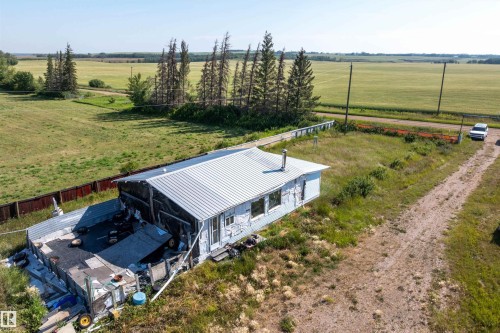 Single-story structure with a metal roof and light-colored siding, situated on a grassy lot - 534072 Range Road 85, Rural Two Hills County, AB 