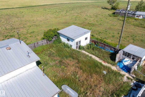 Property featuring multiple structures with metal roofs and a defined pathway - 534072 Range Road 85, Rural Two Hills County, AB 