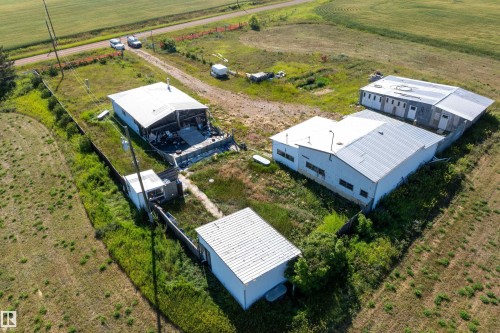 Aerial view showcasing multiple structures on a spacious, undeveloped lot - 534072 Range Road 85, Rural Two Hills County, AB 