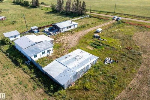 Rural property featuring multiple outbuildings, expansive green space, and visible access road - 534072 Range Road 85, Rural Two Hills County, AB 