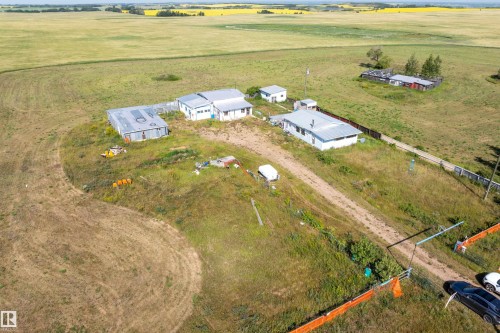 Aerial perspective showcasing multiple structures on a large, open lot - 534072 Range Road 85, Rural Two Hills County, AB 