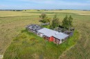 Modest structure with a metal roof surrounded by an expansive, undeveloped landscape - 534072 Range Road 85, Rural Two Hills County, AB 