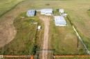 Aerial view showcasing the property's multiple outbuildings and expansive land - 534072 Range Road 85, Rural Two Hills County, AB 