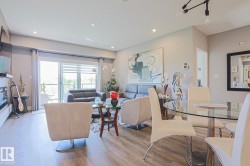 Open-concept living and dining area featuring wood-finish flooring, recessed lighting, and a sliding glass door to an exterior space - 