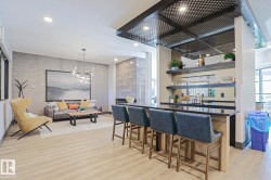 Open concept common area featuring wood-finish flooring - 