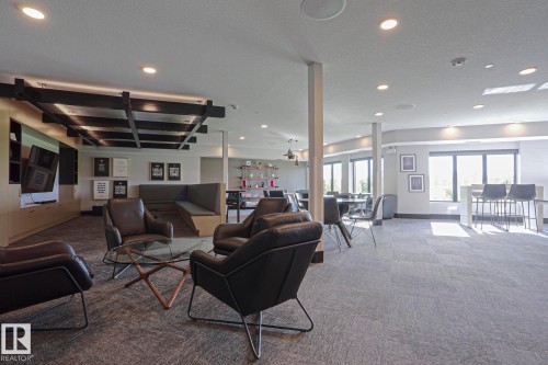 Spacious common area featuring recessed lighting and a decorative ceiling grid - 211 7463 May Common, Edmonton, AB 