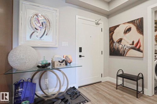 Entryway featuring light wood-finish flooring and neutral wall tones - 211 7463 May Common, Edmonton, AB 