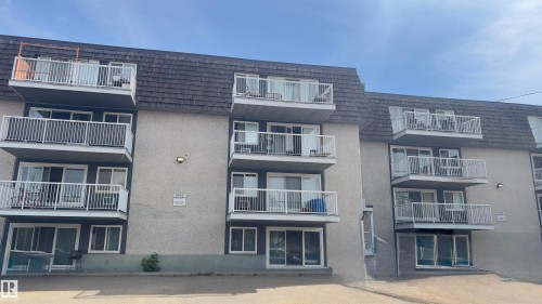 Multi-story building featuring individual balconies with white railings - 311 8604 Gateway Boulevard, Edmonton, AB 