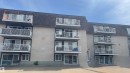 Multi-story building featuring individual balconies with white railings - 311 8604 Gateway Boulevard, Edmonton, AB 