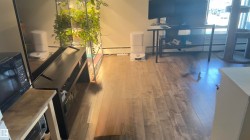 Wood-finish flooring throughout, featuring a natural grain and varied tones - 
