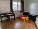 Room featuring wood-finish flooring, a window with dark curtain panels, and light-toned walls - 2724 105 Street Nw, Edmonton, AB  - Indoor Photo Showing Other Room 