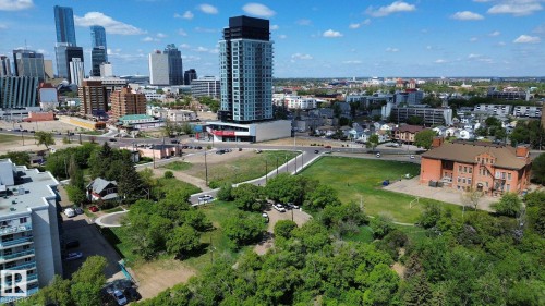 Aerial perspective showcasing urban and suburban architecture, featuring a prominent high-rise building with a dark upper facade - 10173 93 Street, Edmonton, AB 