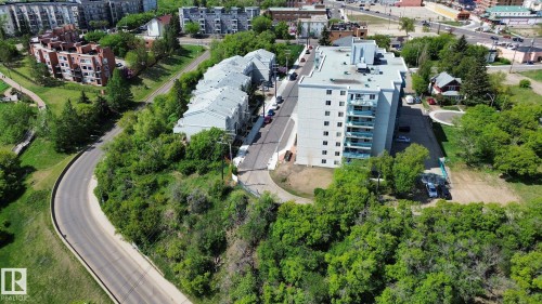Multi-story residential building featuring a light-colored facade and multiple balcony units - 10173 93 Street, Edmonton, AB 
