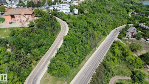 Aerial perspective showcasing a verdant landscape with two winding roadways - 10173 93 Street, Edmonton, AB 