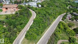 Aerial perspective showcasing a verdant landscape with two winding roadways - 
