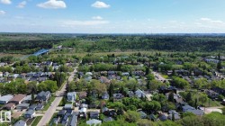 Aerial perspective showcasing a residential area with mature trees and established homes - 