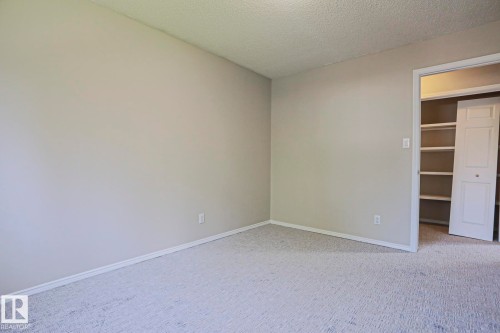 Neutral-toned room with light gray carpeting and white baseboards - 17811 62C Avenue, Edmonton, AB 