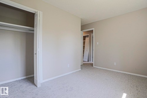 Neutral-toned room featuring light carpet flooring and white trim - 17811 62C Avenue, Edmonton, AB 