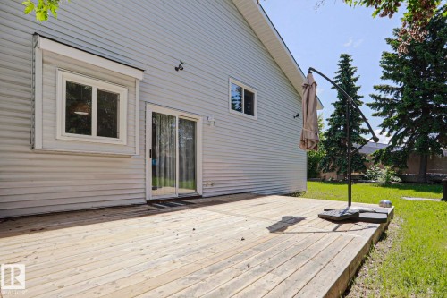 Expansive wood deck with a white vinyl siding exterior - 17811 62C Avenue, Edmonton, AB 