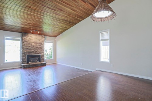 Vaulted wood-paneled ceiling accentuates this spacious room with wood-finish flooring - 17811 62C Avenue, Edmonton, AB 