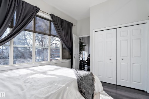 Bedroom featuring dark wood finished floors and a closet - 302 10905 109 Street, Edmonton, AB 