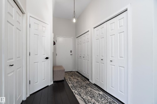Corridor featuring dark wood finished floors - 302 10905 109 Street, Edmonton, AB 