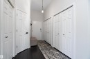 Corridor featuring dark wood finished floors - 302 10905 109 Street, Edmonton, AB 