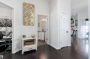 Hall featuring a desk, dark wood-style flooring, and beverage cooler - 302 10905 109 Street, Edmonton, AB 